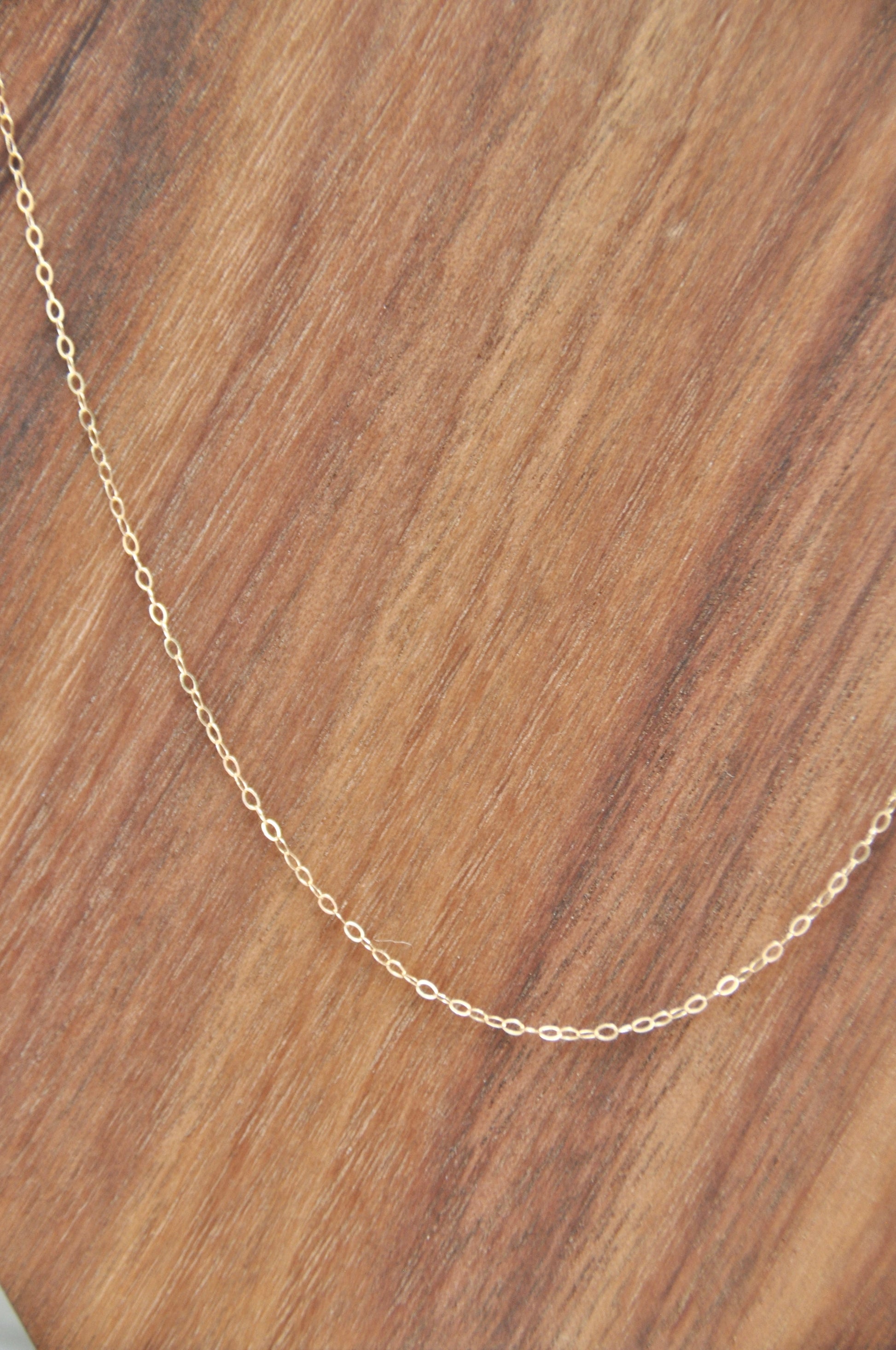 Curb chain necklace in 14kt yellow gold, 1mm thick, 18 inches long, with spring ring clasp