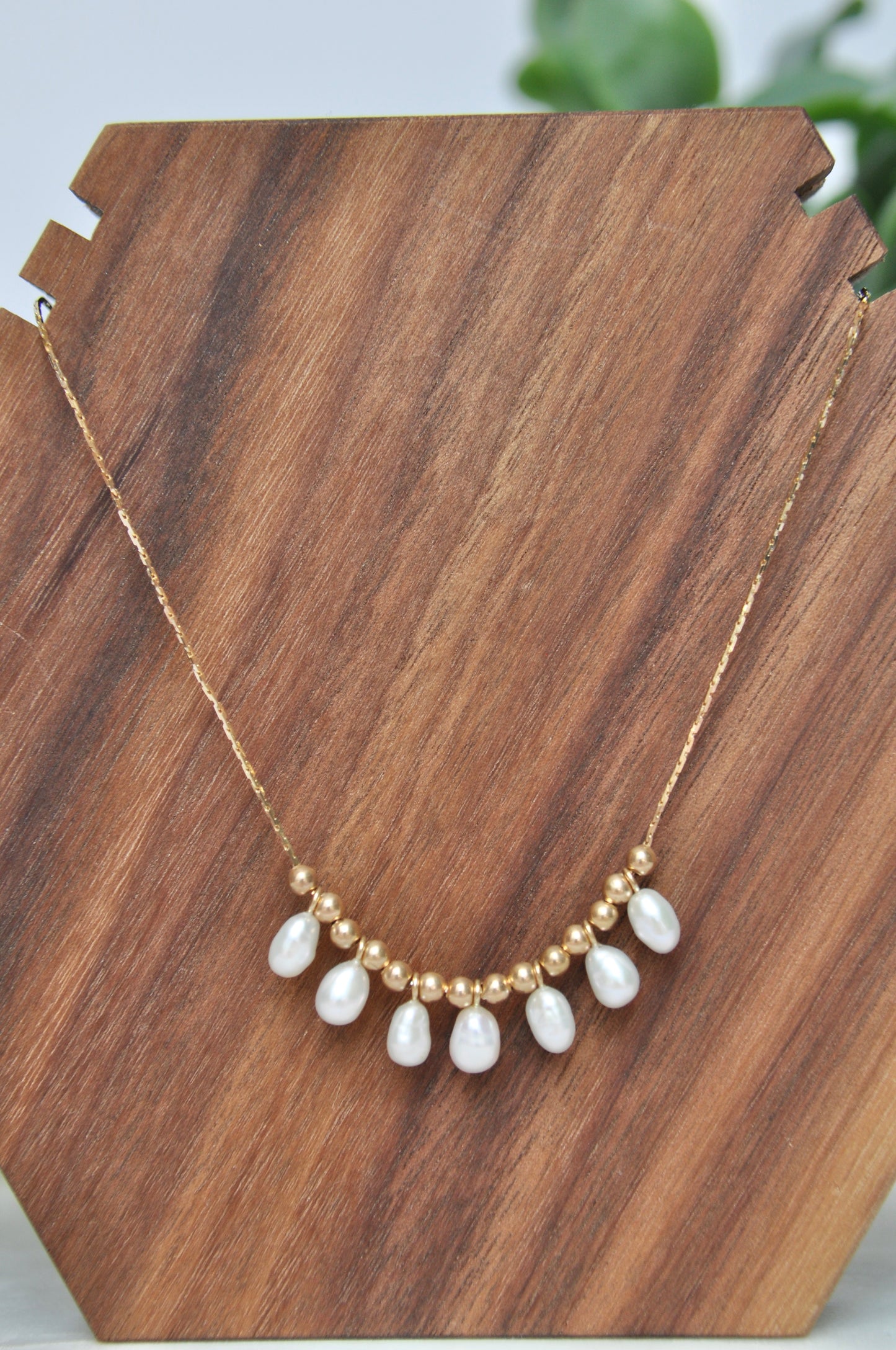 Pearl charm necklace with 7 oval shaped white pearls and 14kt hollow gold beads on 14kt yellow gold chain (some denting on hollow gold beads, some kinks in chain-listed price reflective of notes)