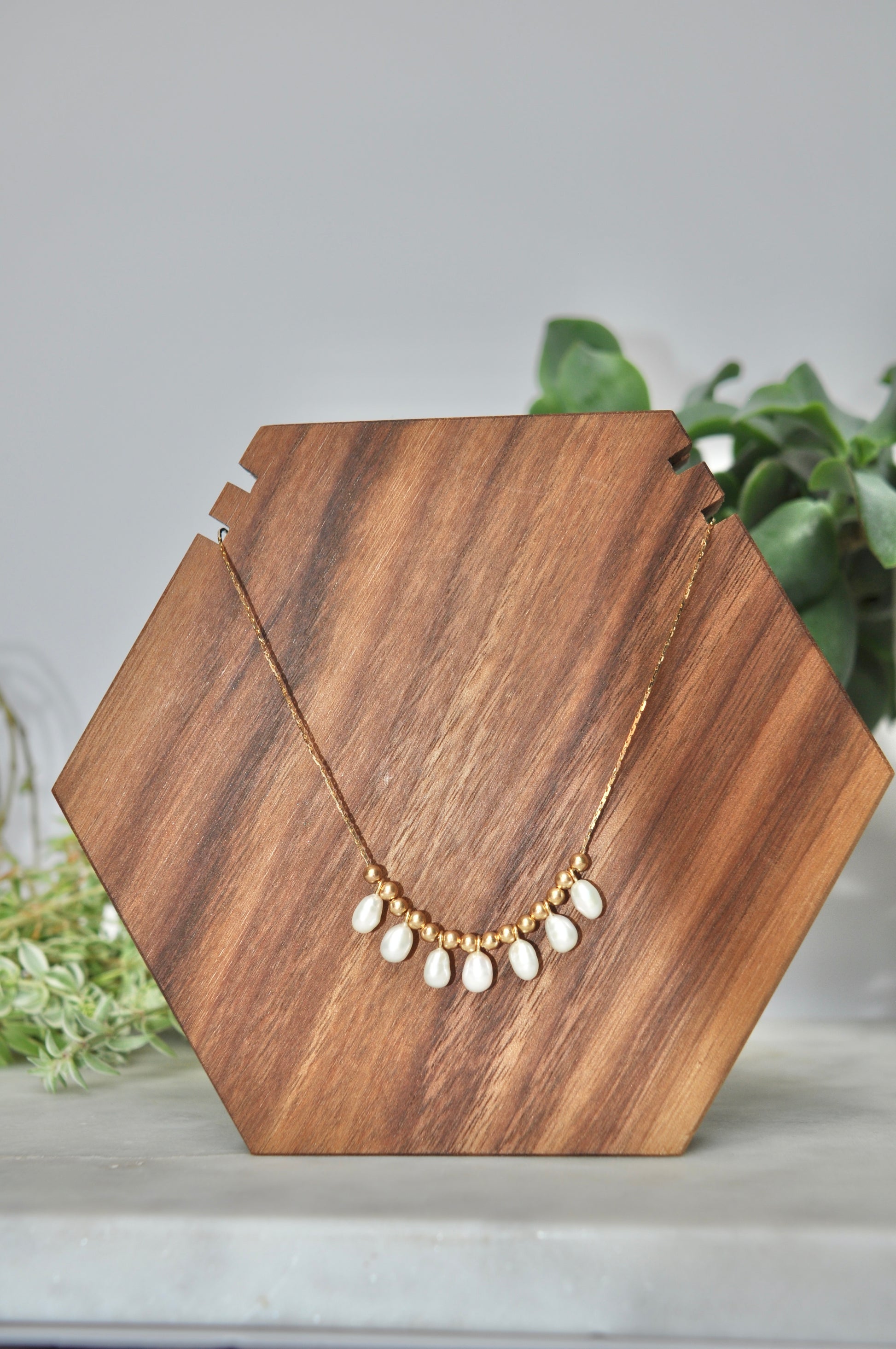 Pearl charm necklace with 7 oval shaped white pearls and 14kt hollow gold beads on 14kt yellow gold chain (some denting on hollow gold beads, some kinks in chain-listed price reflective of notes)