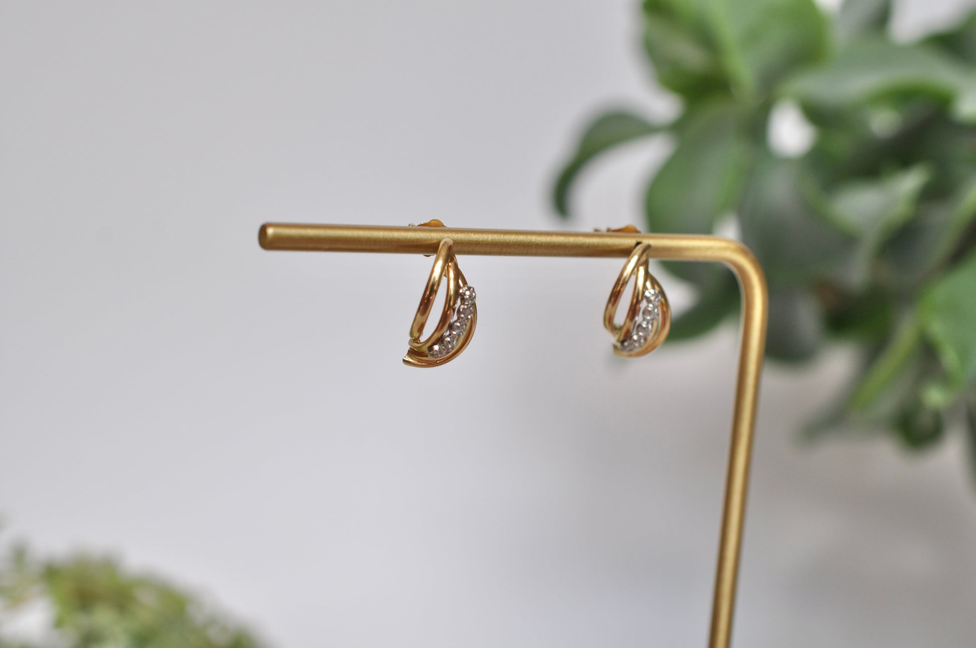 Diamond earrings with curved tube detailing in 14kt yellow gold featuring 5 diamond on each earring (.12ct total weight), stud post earrings