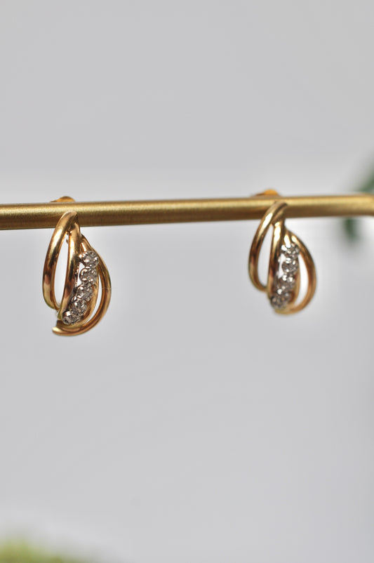 Diamond earrings with curved tube detailing in 14kt yellow gold featuring 5 diamond on each earring (.12ct total weight), stud post earrings