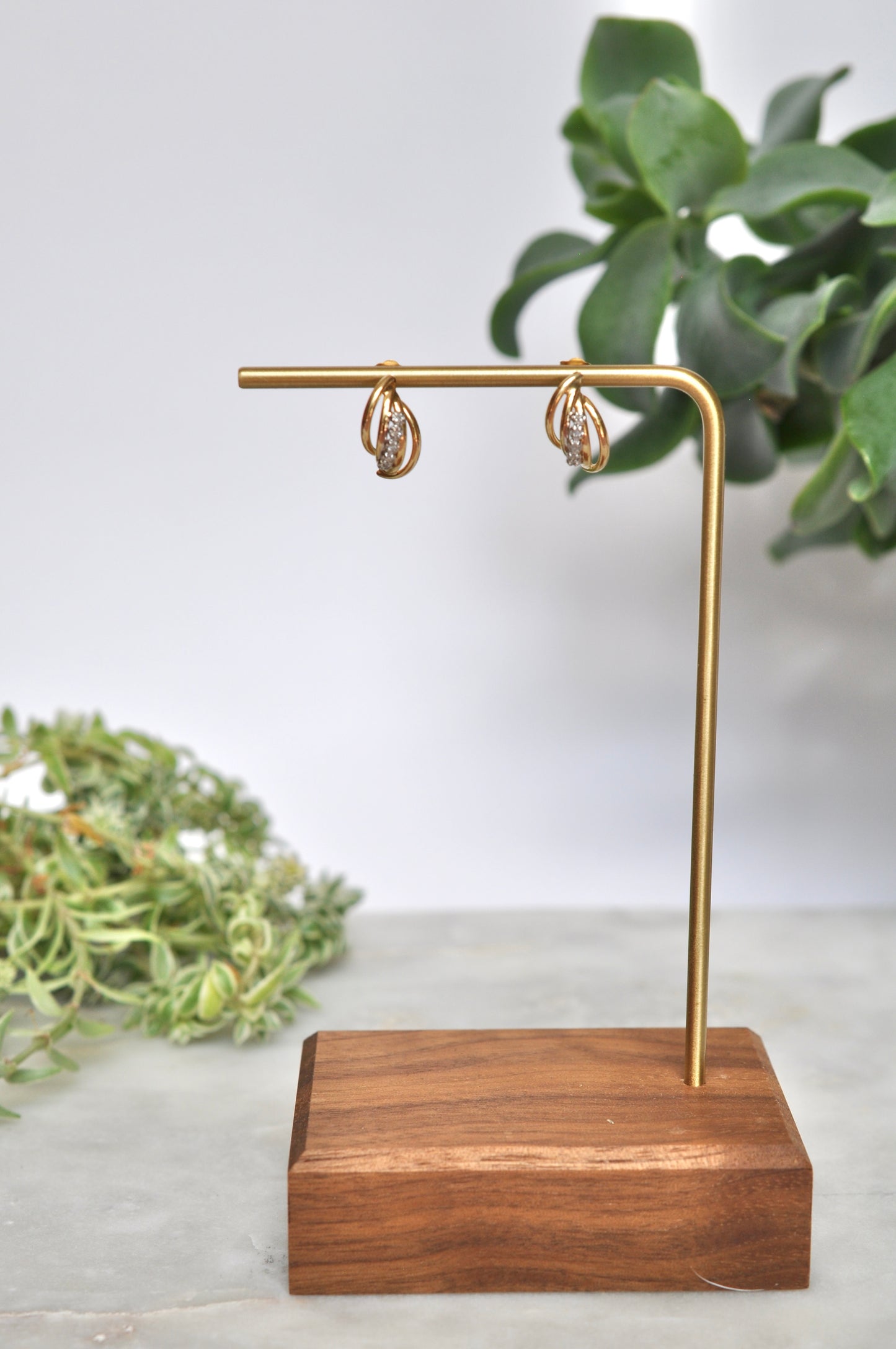 Diamond earrings with curved tube detailing in 14kt yellow gold featuring 5 diamond on each earring (.12ct total weight), stud post earrings