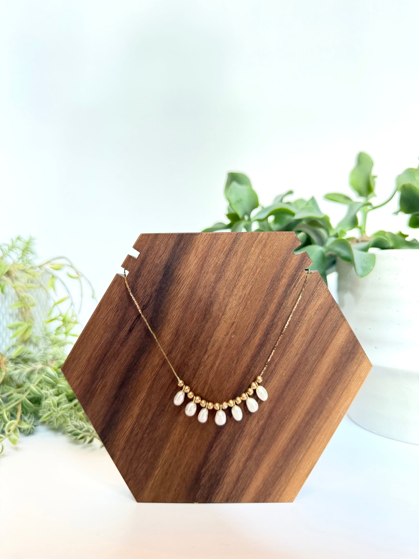 Pearl charm necklace with 7 oval shaped white pearls and 14kt hollow gold beads on 14kt yellow gold chain (some denting on hollow gold beads, some kinks in chain-listed price reflective of notes)