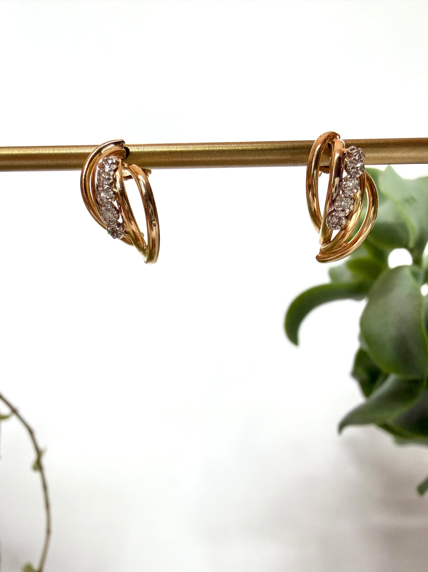 Diamond earrings with curved tube detailing in 14kt yellow gold featuring 5 diamond on each earring (.12ct total weight), stud post earrings