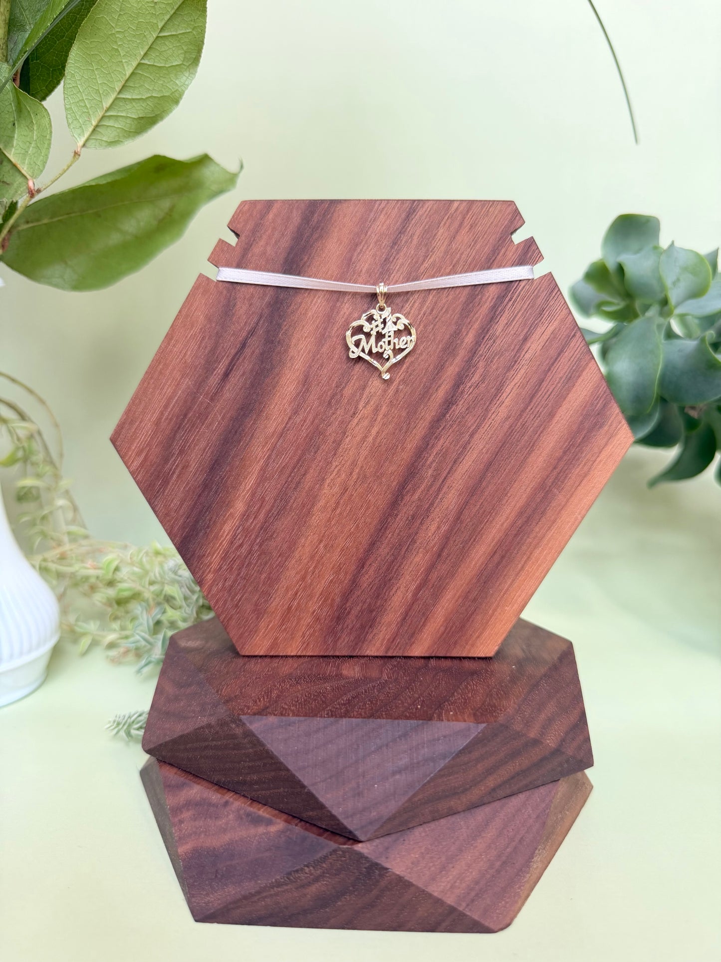 #1 Mother encased in heart with scroll detailing in 14kt yellow gold, approximately 17mm wide, 16mm long, 0.89g