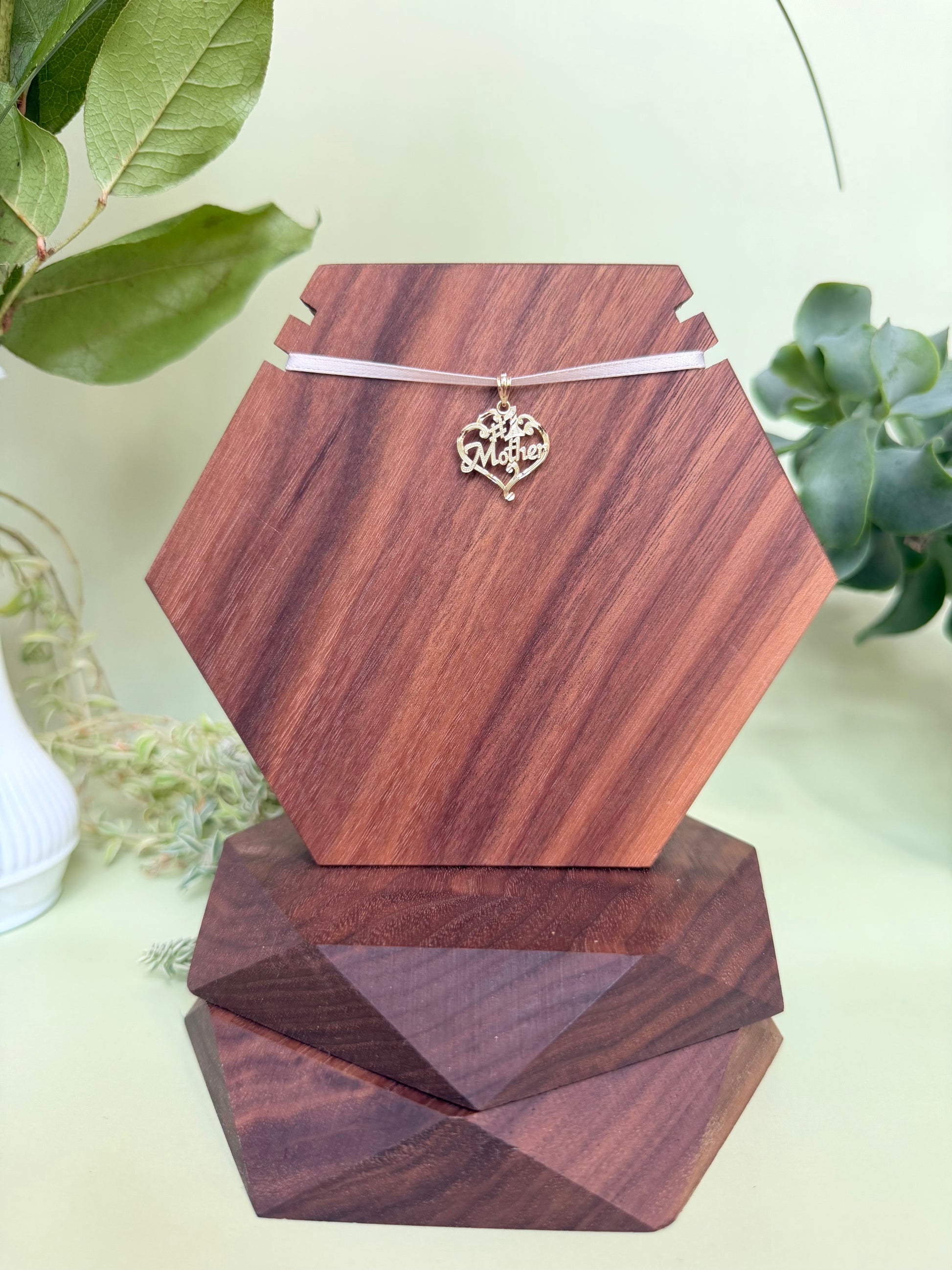 #1 Mother encased in heart with scroll detailing in 14kt yellow gold, approximately 17mm wide, 16mm long, 0.89g